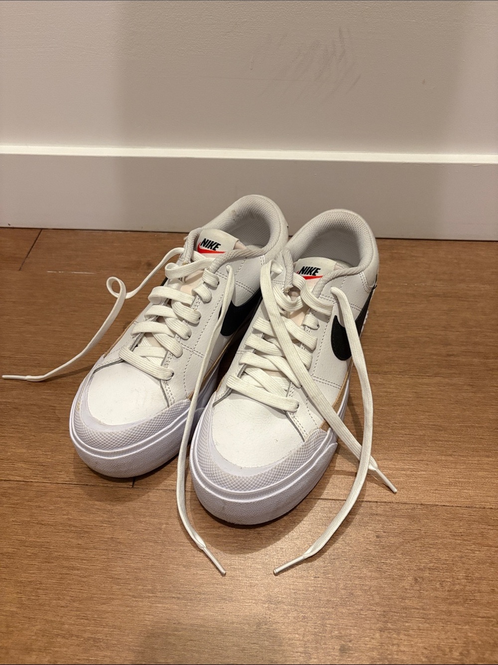 Nike Women's White Sneakers with Black Swoosh